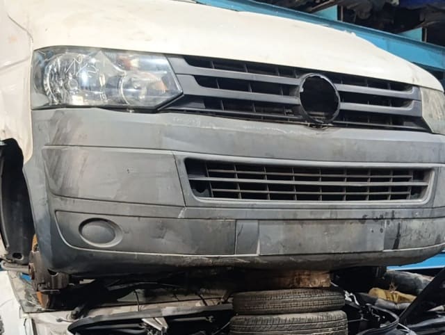 White Volkswagen Transporter van front halfcut — headlight, grille and grey front bumper, Sharjah market