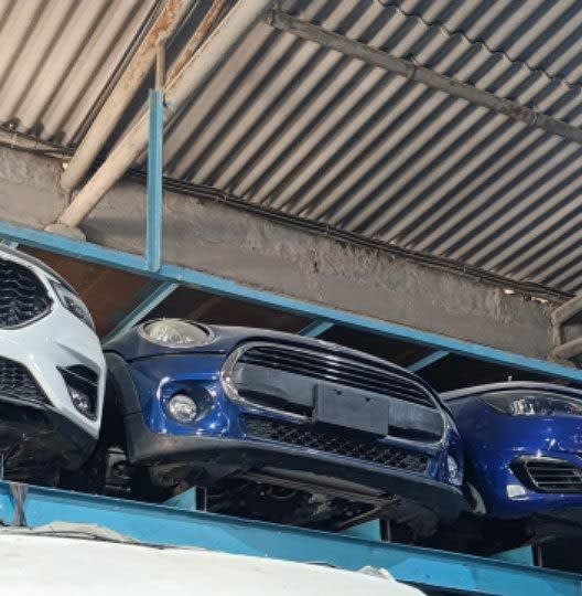 Blue MINI Cooper front halfcut on rack — bumper, grille, headlight and fog lights, Sharjah market