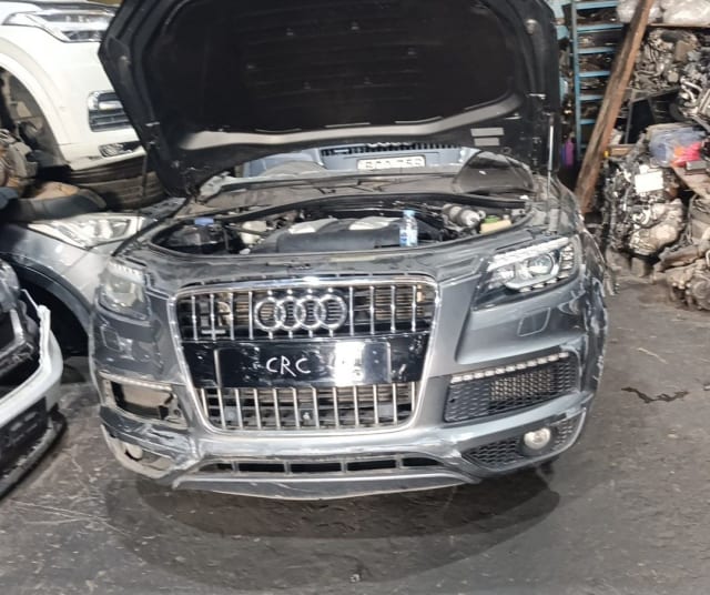 Grey Audi Q7 front halfcut with hood open, chrome grille, headlights, bumper and engine bay, Sharjah market