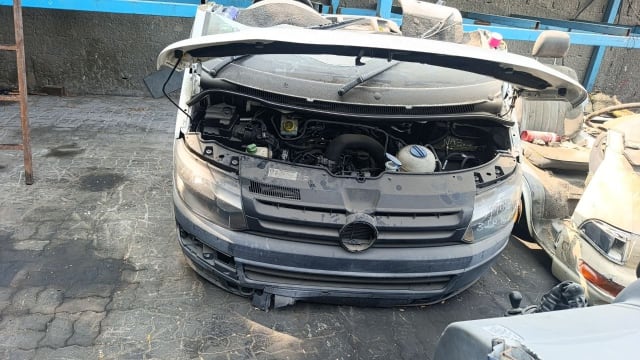 White Volkswagen Transporter front halfcut, hood open, engine, grey bumper and headlights, Sharjah market