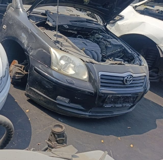 Black Toyota Avensis front halfcut, hood open with engine, bumper, grille and headlight, Sharjah market