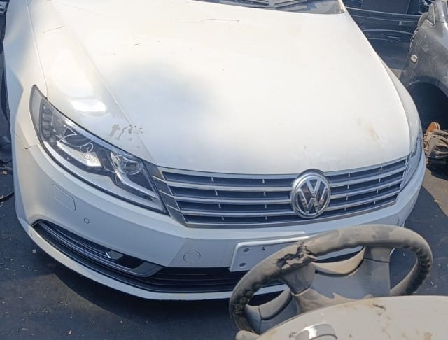 White Volkswagen CC halfcut front: hood, chrome grille, headlight and bumper, Sharjah market
