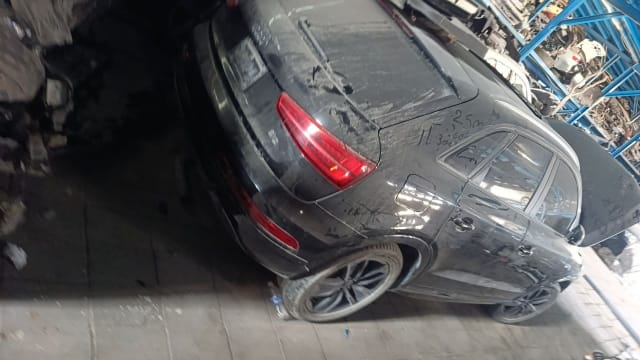 Dusty black Audi Q3 SUV for parts, rear three-quarter view with tail lights, doors and alloys, Sharjah market