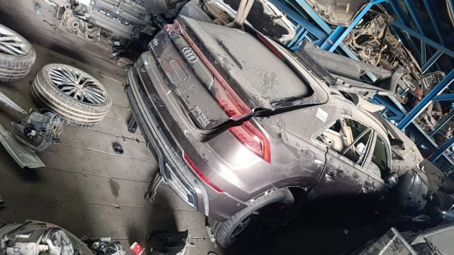 Dark grey Audi Q8 halfcut rear view: tailgate, LED tail lights and rear bumper, Sharjah market