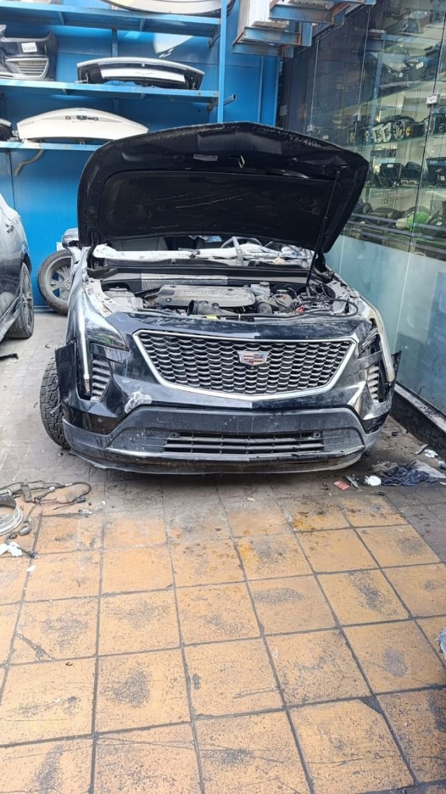 Black Cadillac XT4 front halfcut, hood open: engine, grille, headlights and bumper, Sharjah market