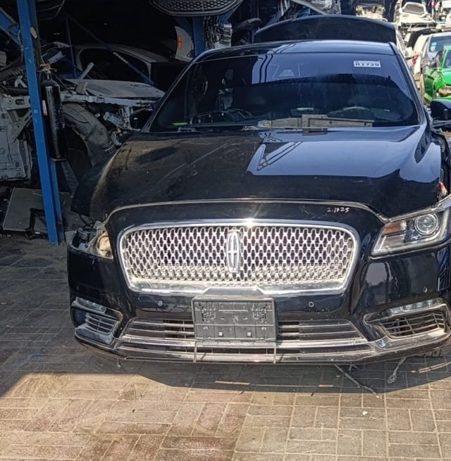 Black Lincoln Continental halfcut front: chrome grille, bumper, hood and right headlight, Sharjah market