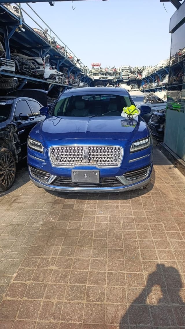 Blue Lincoln Nautilus SUV for parts, front view: chrome grille, LED headlights, hood and bumper, Sharjah market