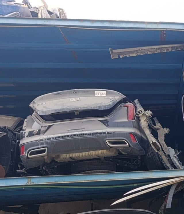 Dark grey Cadillac CT4 rear halfcut with trunk lid, bumper, taillights and dual exhausts, Sharjah market