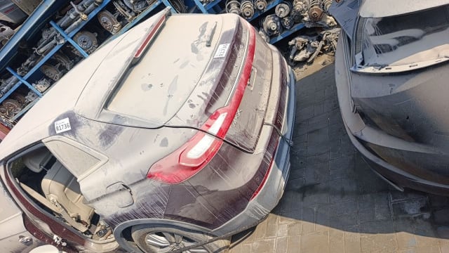 Dusty burgundy Lincoln MKX SUV rear: tailgate, LED tail lights, bumper and beige interior, Sharjah market