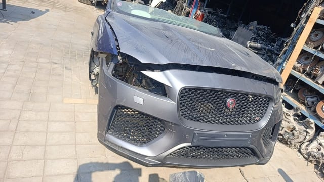 Grey Jaguar F-Pace front halfcut with bumper, mesh grille and creased hood, Sharjah market