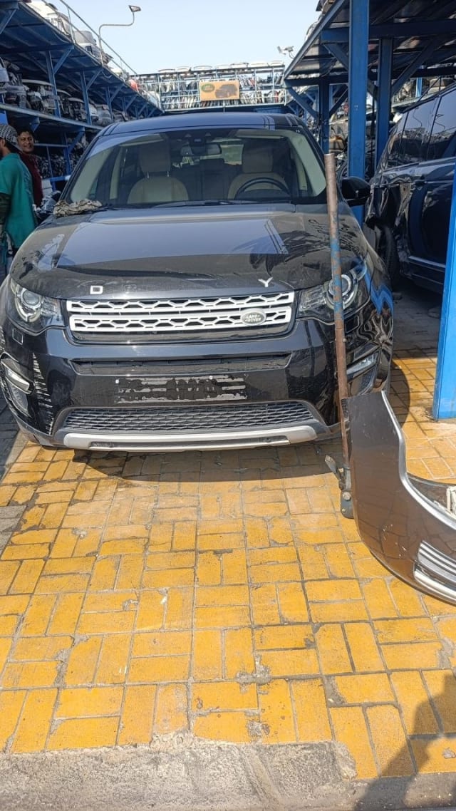 Black Land Rover Discovery Sport car for parts, front view with grille, headlights and bumper, Sharjah market