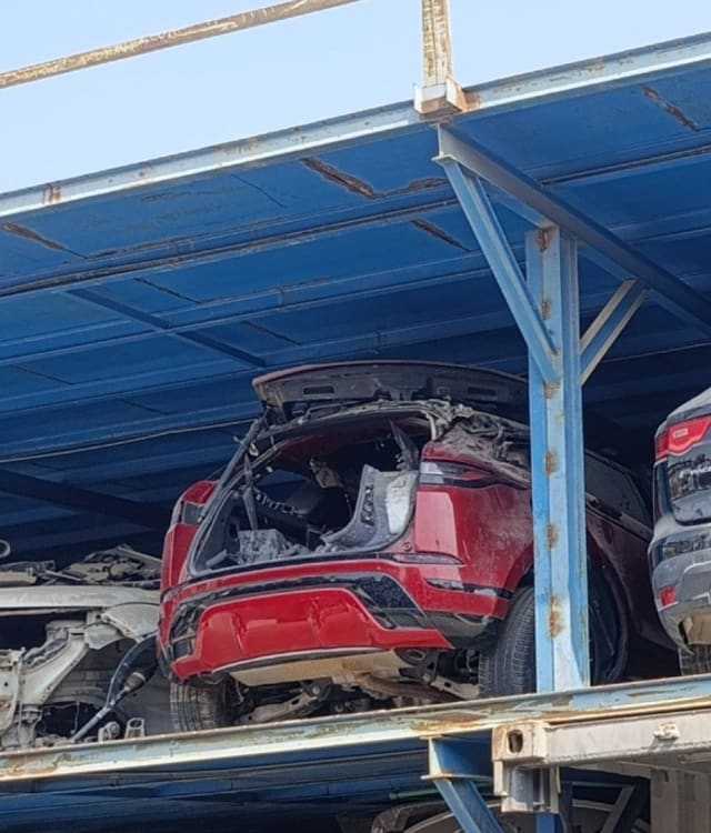 Red Range Rover Evoque for parts, rear view with tailgate removed, bumper and tail light, Sharjah market