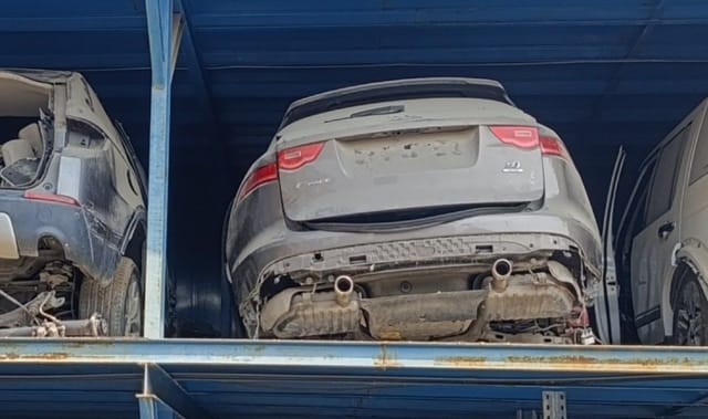 Grey Jaguar F-Pace rear halfcut on rack — tailgate, tail lights and dual exhaust, Sharjah market