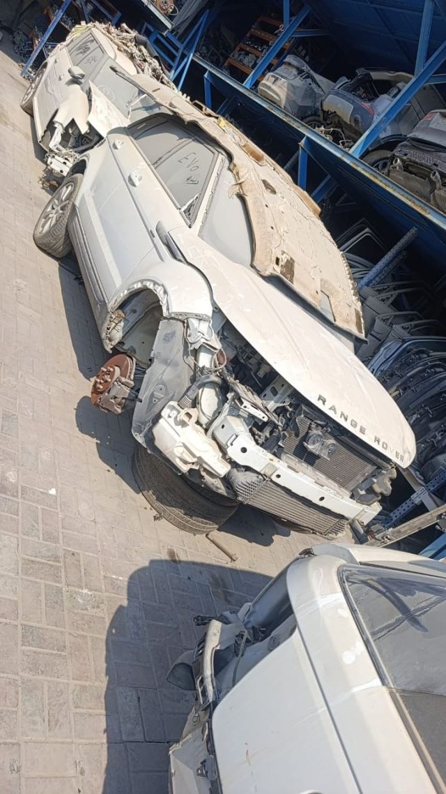 White Range Rover Evoque halfcut — hood, radiator, fender and exposed brake disc, Sharjah market
