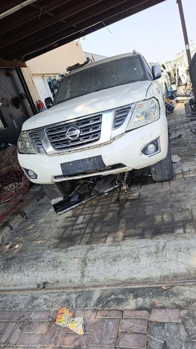 White Nissan Patrol SUV for parts, front view with grille, headlights, hood and bumper, Sharjah market