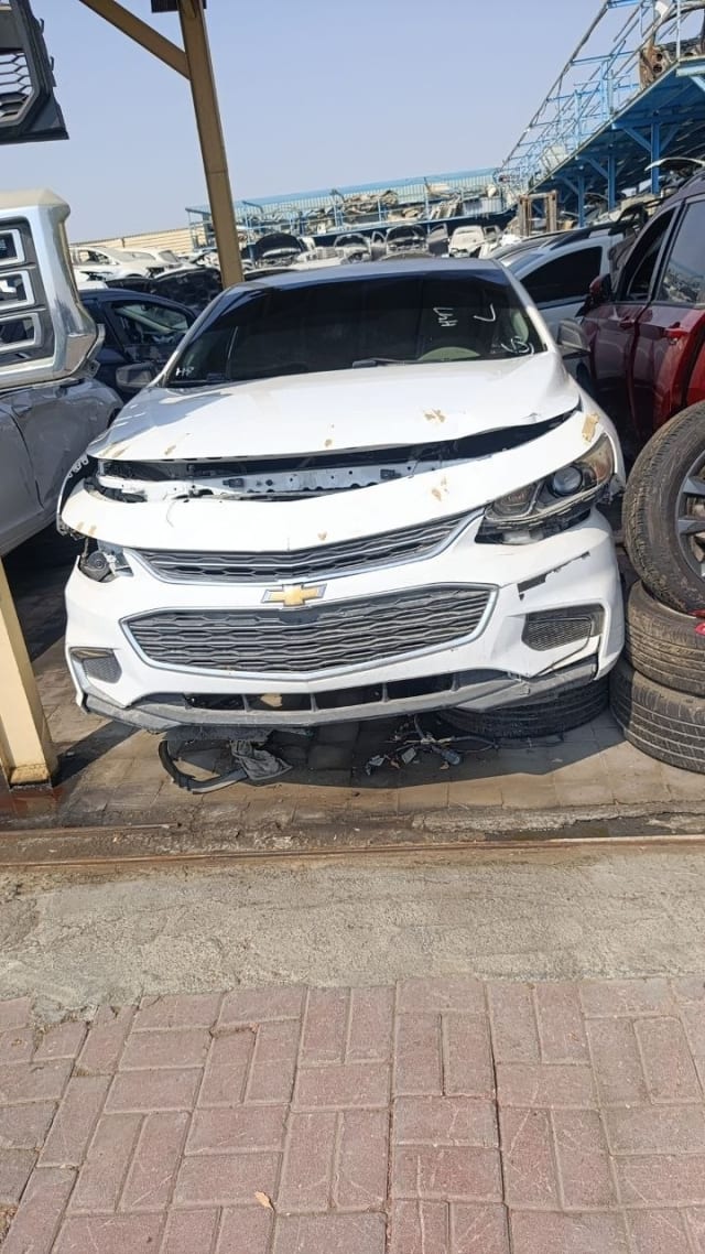 White Chevrolet Malibu car for parts with damaged hood, front bumper and grille, Sharjah market