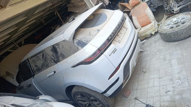 White Range Rover Evoque rear view — tailgate, tail lights, rear bumper and alloy wheel, Sharjah market