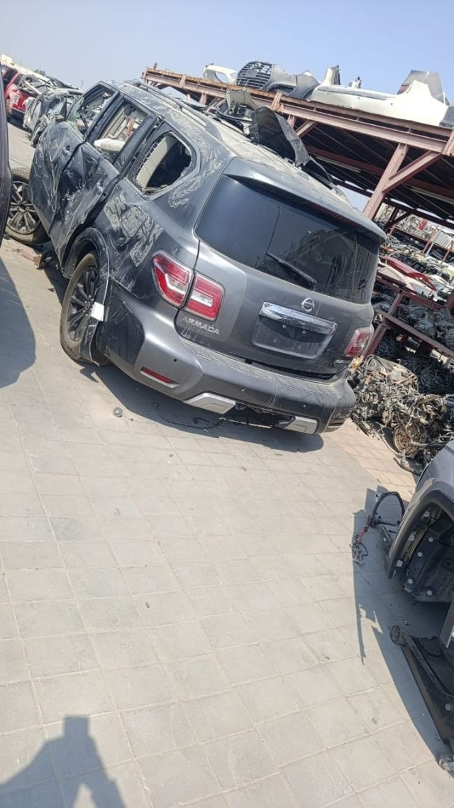 Dark grey Nissan Armada car for parts, rear view with tailgate, tail lights and bumper, Sharjah market