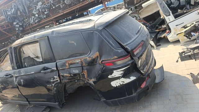 Black Jeep Grand Cherokee rear halfcut with tailgate, taillights and damaged quarter panel, Sharjah market