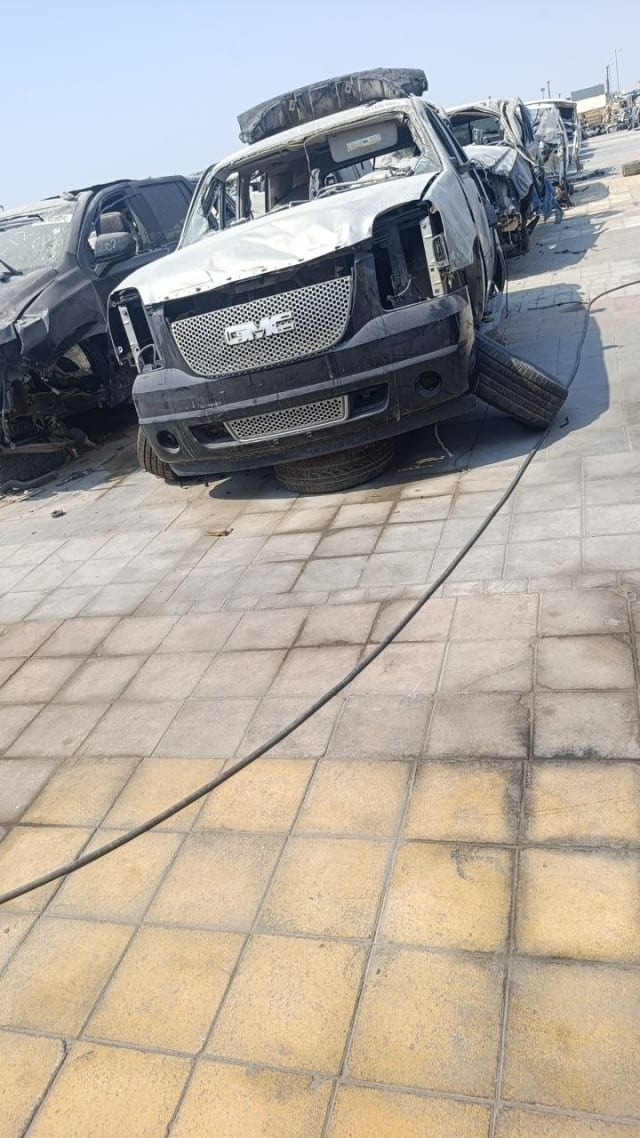 Silver GMC Yukon Denali car for parts with mesh grille, front bumper and crumpled hood, Sharjah market