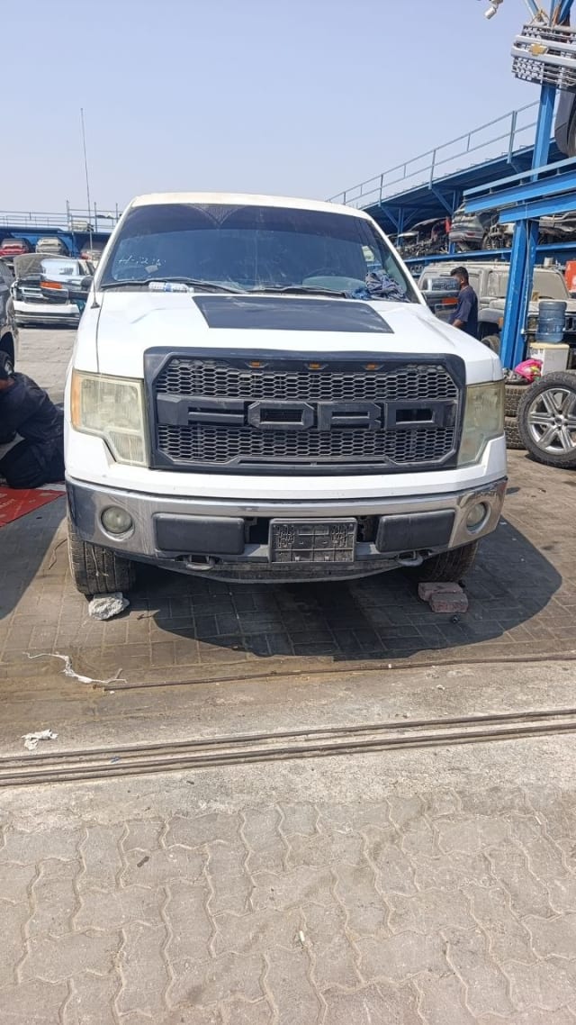 White Ford F150 pickup front view with black Raptor-style grille, headlights and bumper, Sharjah market