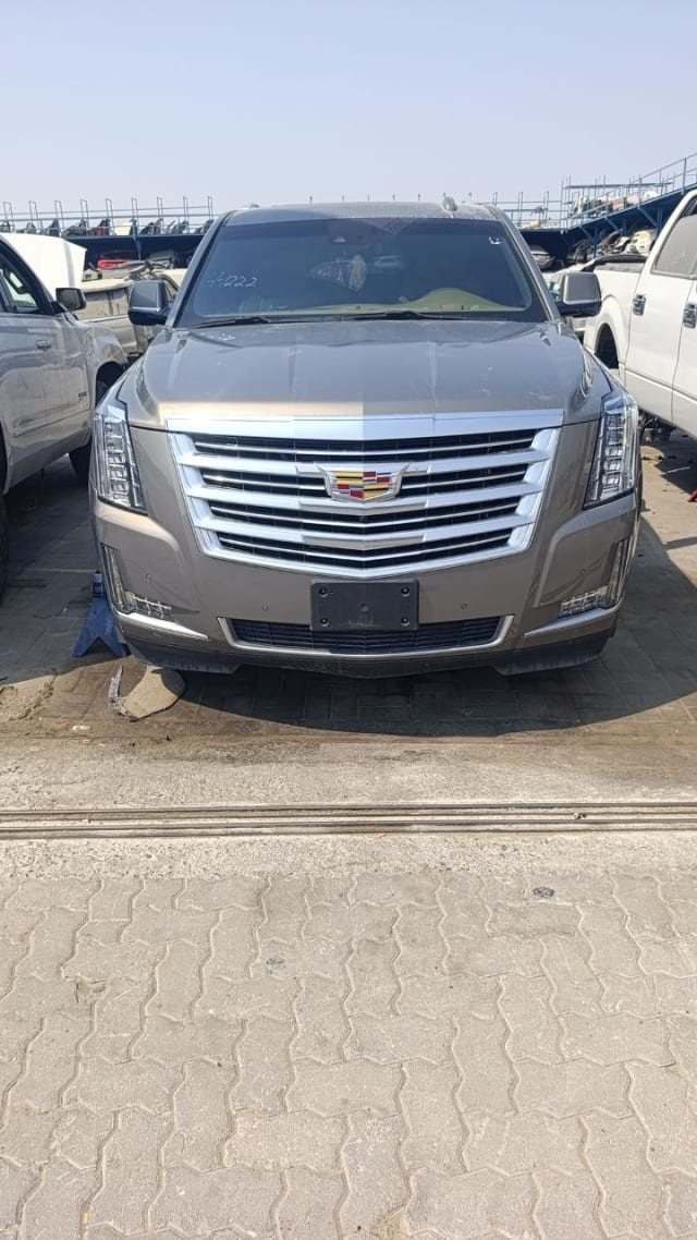 Bronze-grey Cadillac Escalade SUV for parts, front view with chrome grille and LED headlights, Sharjah market