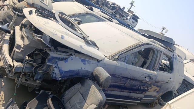 Dark blue Ford Explorer halfcut with lifted hood, stripped engine bay and loose seats, Sharjah market