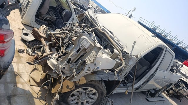 White Chevrolet Silverado pickup for parts, front stripped showing engine bay and cab, Sharjah market