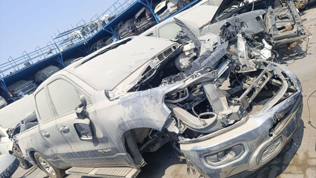 Silver RAM 1500 pickup halfcut — hood, doors, fender and damaged chrome front bumper, Sharjah market