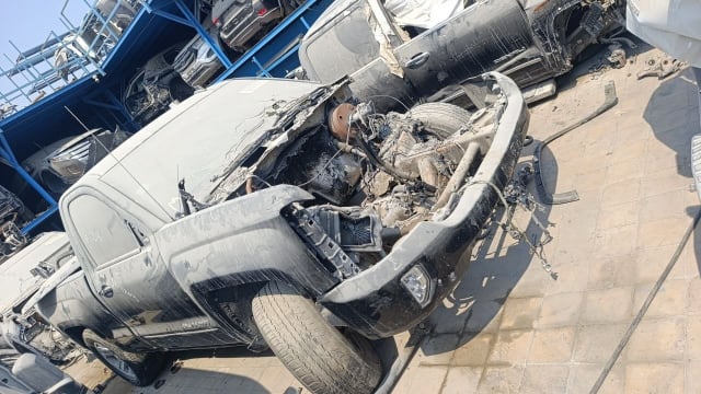 Dark grey Chevrolet Silverado pickup for parts with damaged front end and exposed engine bay, Sharjah market