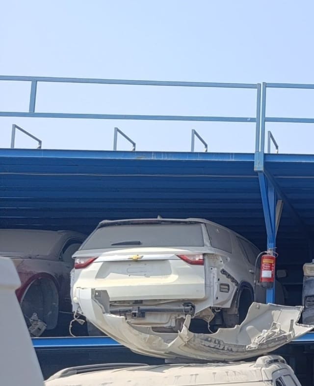 White Chevrolet Traverse car for parts — tailgate, taillights and damaged rear bumper, Sharjah market