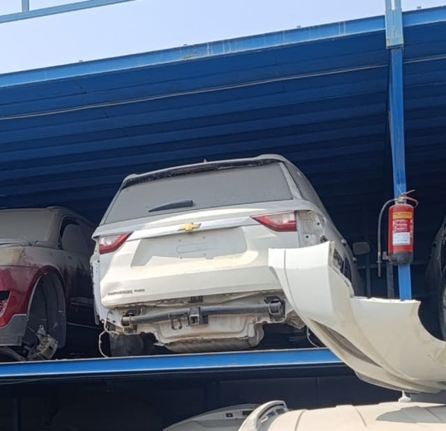 White Chevrolet Traverse rear halfcut — tailgate, tail lights and detached rear bumper, Sharjah market