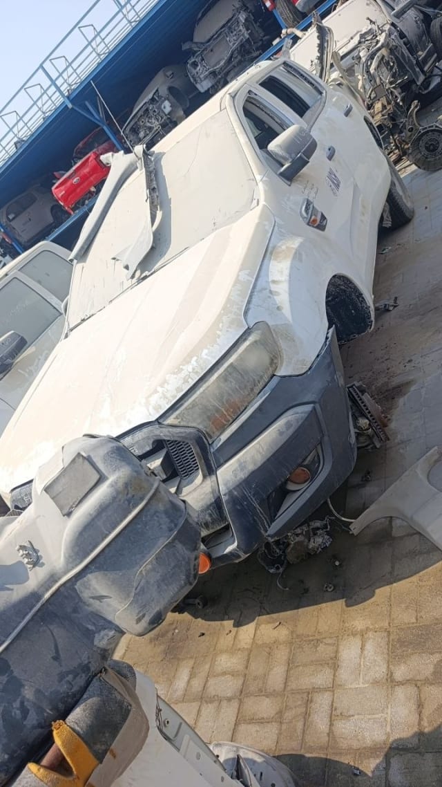 White Toyota Hilux for parts with dark grey front bumper, grille, headlight and hood, Sharjah market