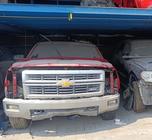 Red Chevrolet Silverado 1500 for parts: Z71 chrome grille, silver bumper and fog lights, Sharjah market