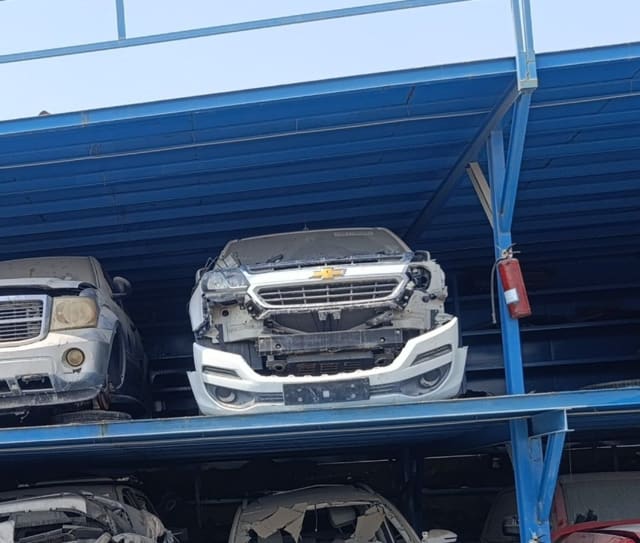 White Chevrolet TrailBlazer front halfcut on rack — bumper, grille, hood and headlight, Sharjah market