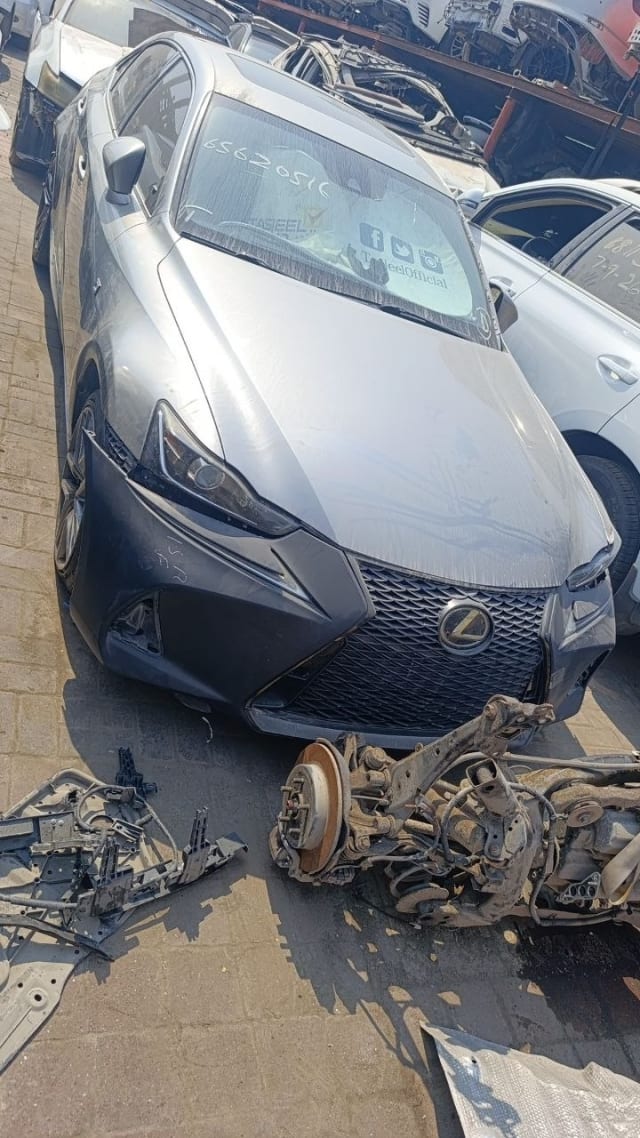 Silver Lexus IS sedan for parts — spindle grille, headlights, hood and rear suspension, Sharjah market