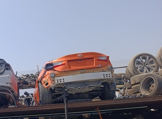 Orange Lexus RC F coupe rear view — trunk lid, taillights, bare bumper bar, Sharjah parts market