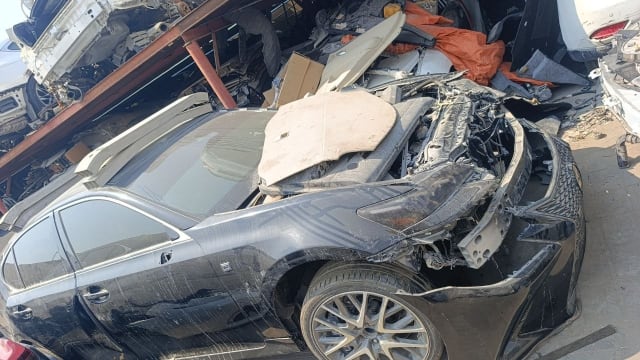 Black Lexus GS sedan halfcut — front bumper, mesh grille, headlight, fender and alloy wheel, Sharjah market