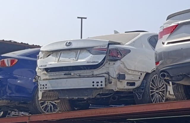 White Lexus GS sedan for parts, rear view — damaged trunk lid, tail lights, bumper bar exposed, Sharjah market