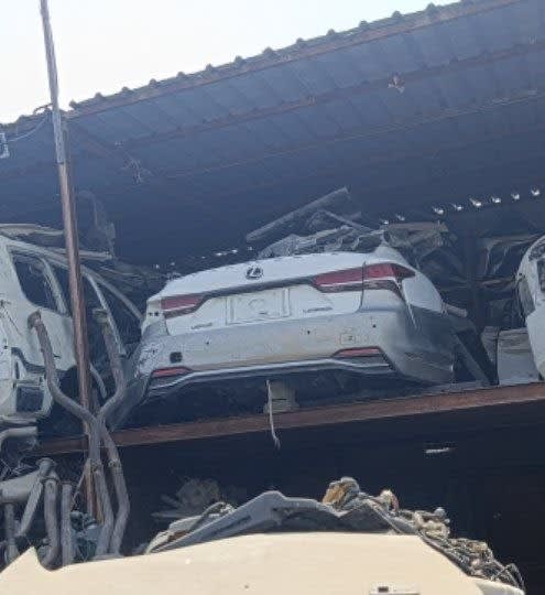 White Lexus LS rear halfcut on a shed rack — trunk lid, taillights and rear bumper, Sharjah market