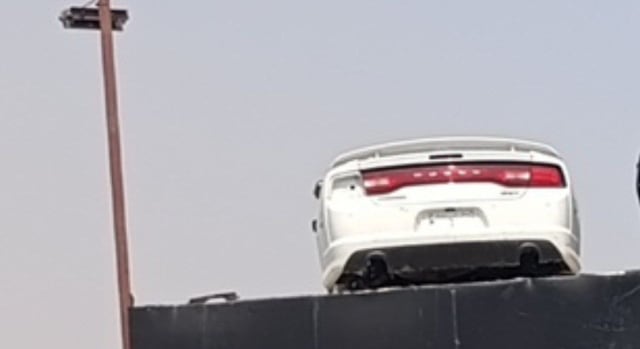 White Dodge Charger rear view: LED tail light bar, spoiler, trunk lid and rear bumper, Sharjah market