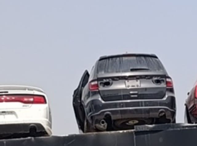 Dark grey Dodge Durango car for parts, rear view with tailgate, taillights and bumper, Sharjah market
