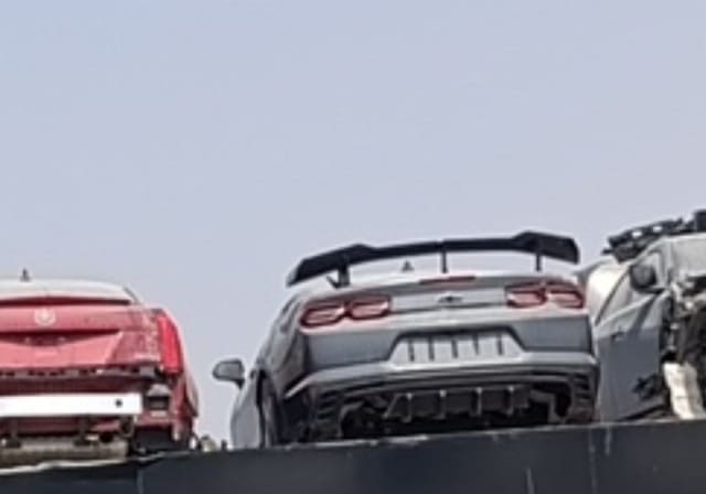 Grey Chevrolet Camaro coupe rear view with tail lights, rear wing and diffuser, Sharjah market