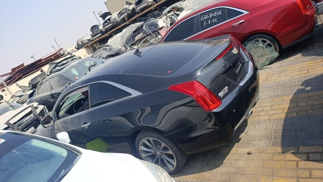 Black Cadillac ATS coupe for parts, rear three-quarter view with taillights and alloy wheel, Sharjah market