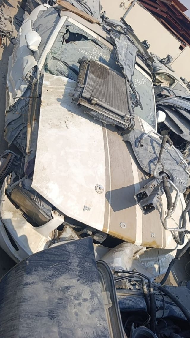 White Ford Mustang halfcut with striped hood, radiator and condenser on top, Sharjah market