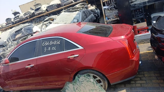 Red Cadillac ATS sedan car for parts, rear side view with doors, trunk and taillights, Sharjah market
