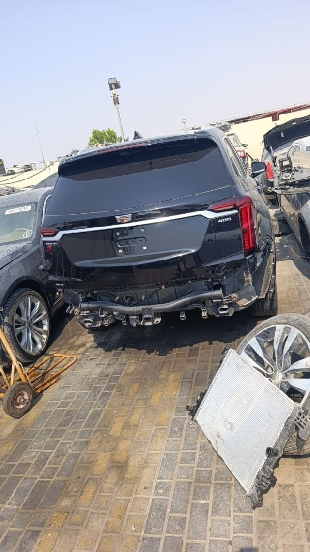 Black Cadillac XT6 SUV rear view with tailgate and taillights, bumper cover removed, Sharjah parts market