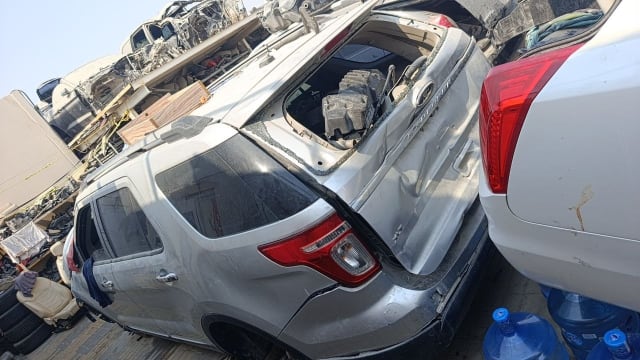 Silver Ford Explorer SUV for parts — rear quarter, taillight, doors and damaged liftgate, Sharjah market
