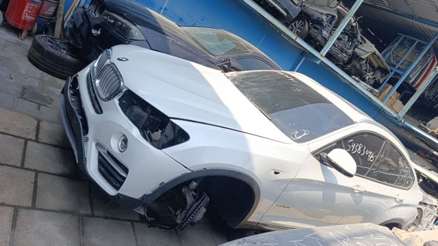 White BMW X4 car for parts — hood, kidney grille, front bumper, fender and doors, Sharjah market