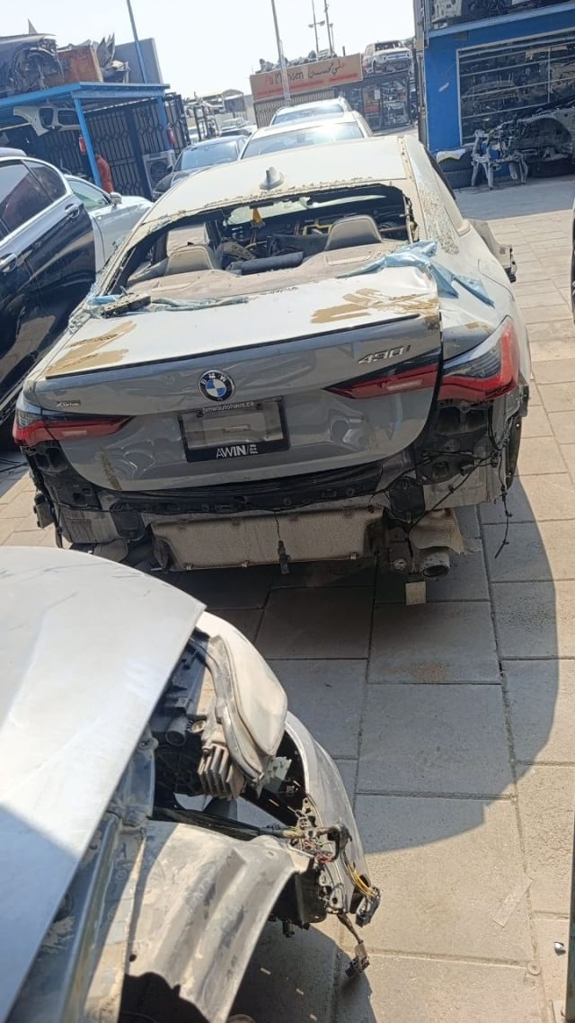 Grey BMW 430i convertible car for parts, rear view with trunk lid and taillights, Sharjah market